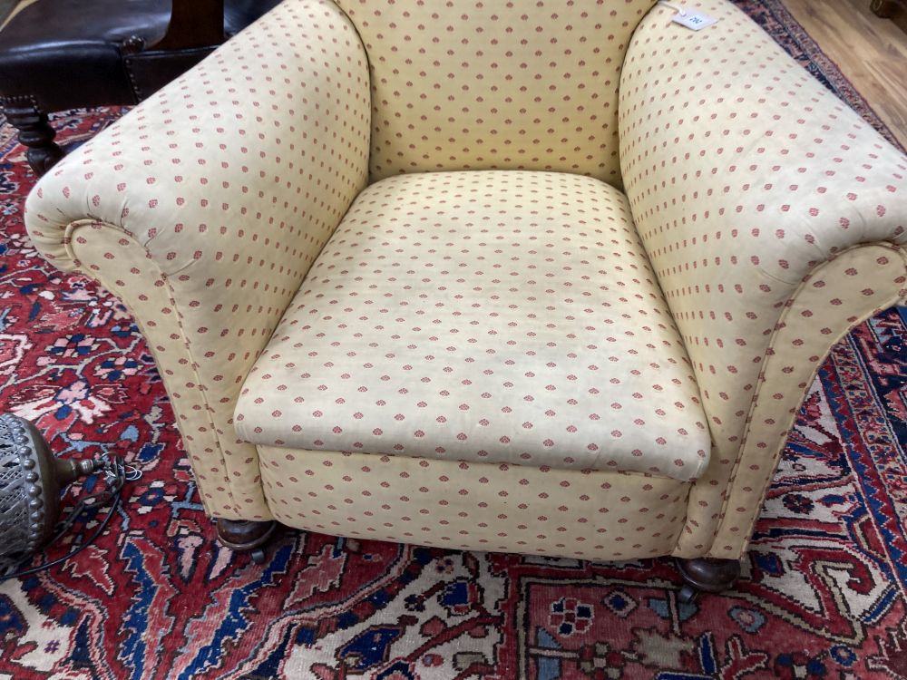 An early 20th century upholstered club armchair